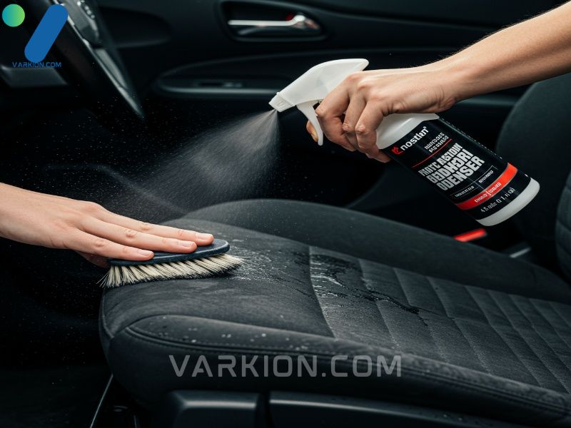 a-close-up-action-shot-of-a-person-using-a-spray-bottle-of-car-fabric-cleaner-on-a-cloth-car-seat
