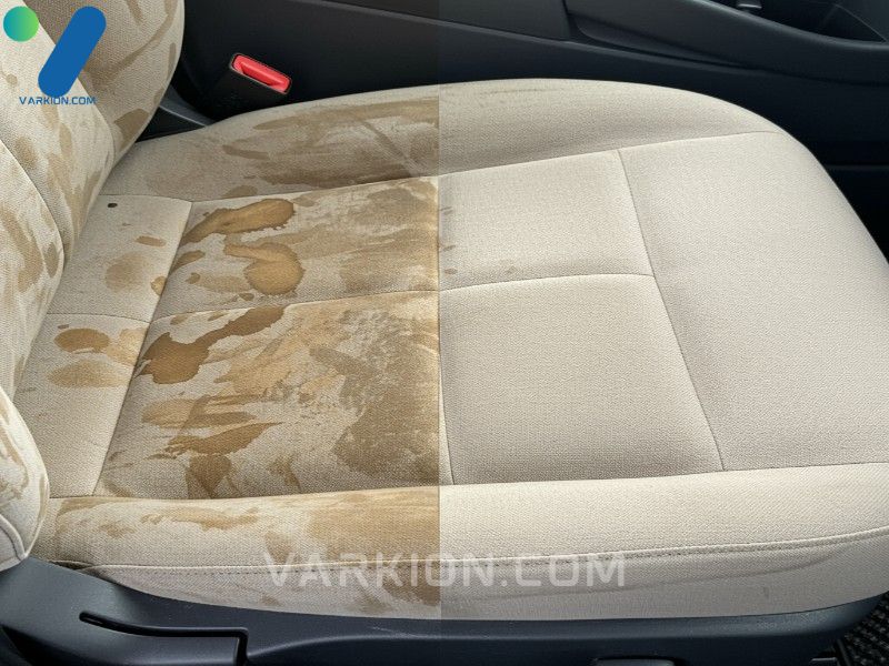 a-detailed-high-angle-close-up-shot-showing-a-dramatic-before-and-after-of-a-heavily-stained-light-colored-fabric-car-seat