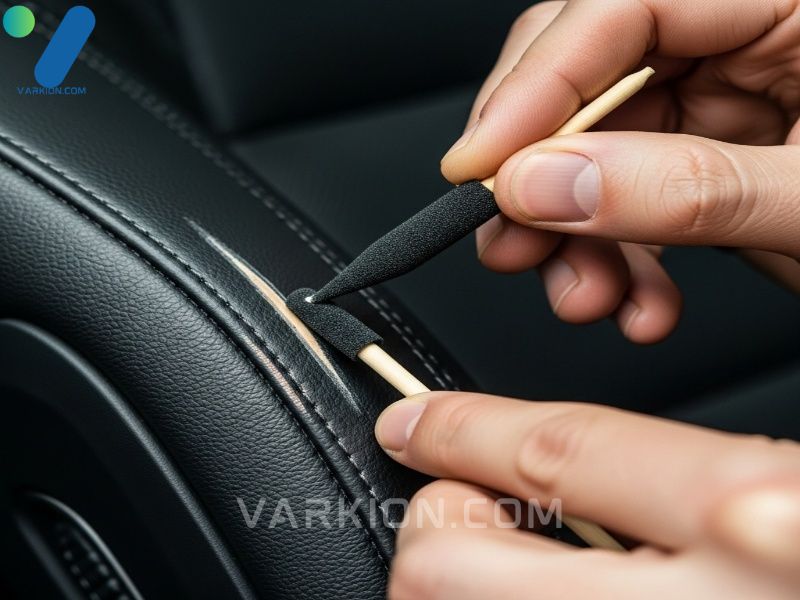 applying-dye-to-repaired-leather-scratch-using-a-specialized-car-interior-scratch-remover-kit