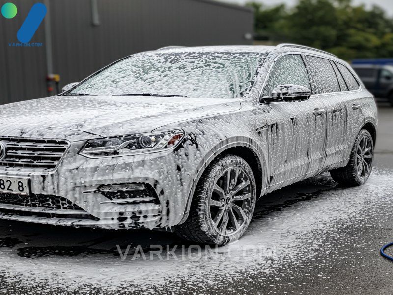 car-covered-entirely-in-thick-white-snow-foam-during-a-professional-pre-wash