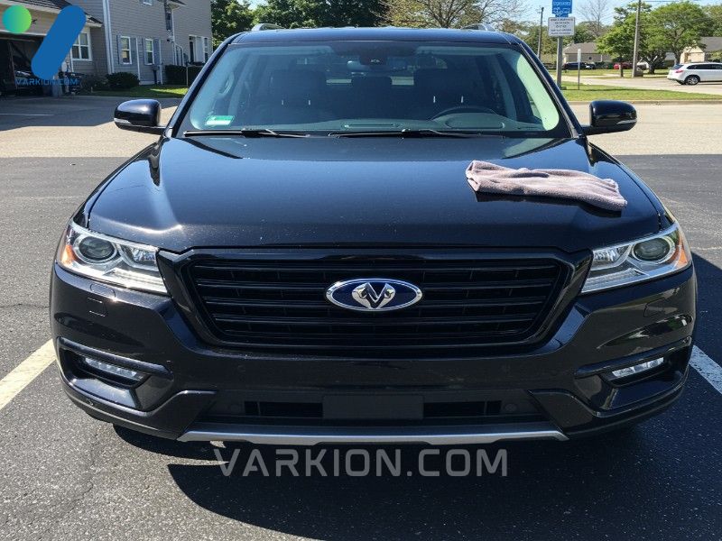 clean-glossy-black-suv-parked-in-the-sun-after-a-wash-microfiber-towel-on-the-hood