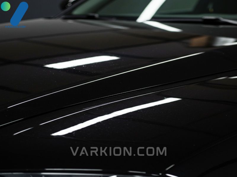 close-up-of-a-mirror-like-reflection-on-a-freshly-waxed-black-car-hood