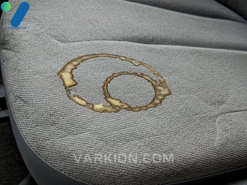 close-up-view-of-difficult-protein-and-dye-stains-on-fabric-car-seat-upholstery-requiring-a-powerful-deep-cleaning-solution