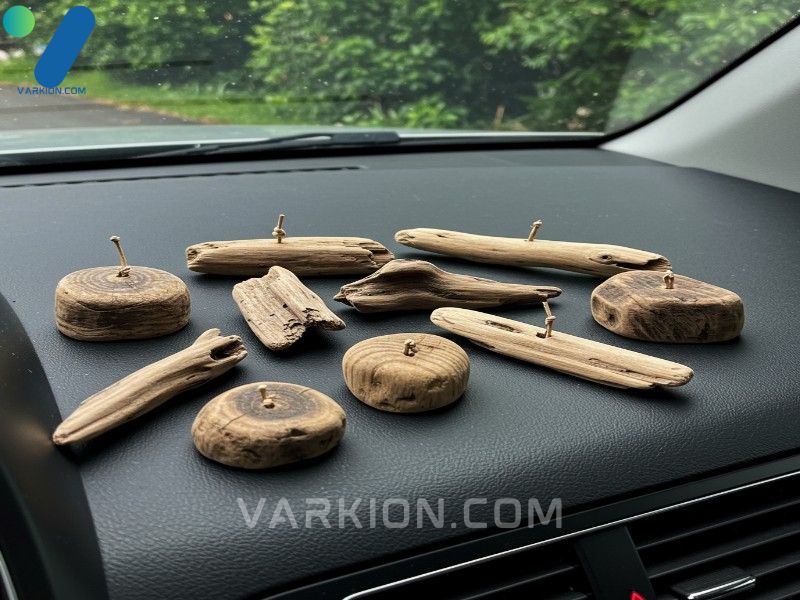 collection-of-uniquely-shaped-natural-driftwood-car-fresheners-on-a-dashboard