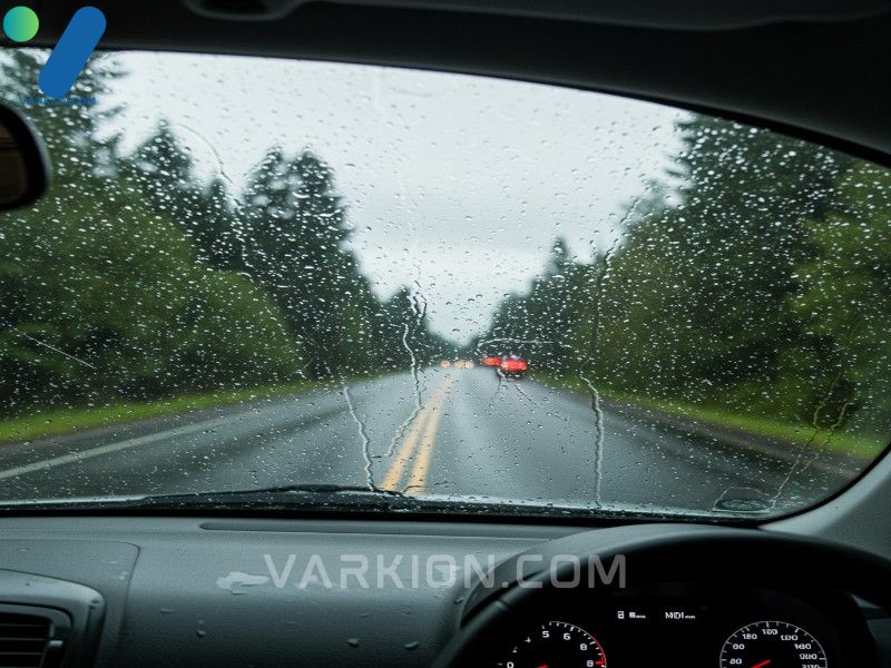 confident-driver-smiles-through-a-perfectly-clean-windshield-on-a-rainy-road