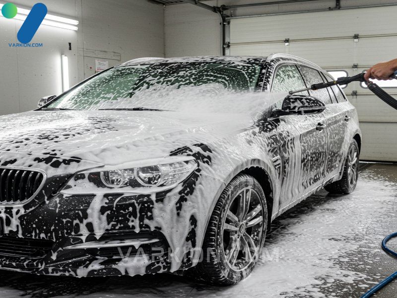 dark-car-covered-in-thick-white-snow-foam-applied-by-a-foam-cannon