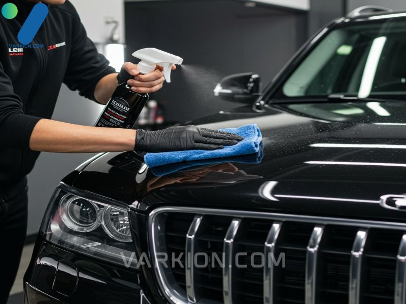 detailer-quickly-cleaning-black-suv-hood-with-spray-and-towel