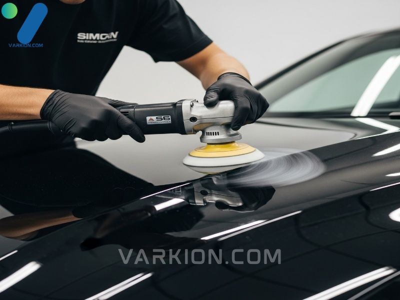detailer-using-a-da-polisher-on-the-hood-of-a-black-car-for-paint-correction