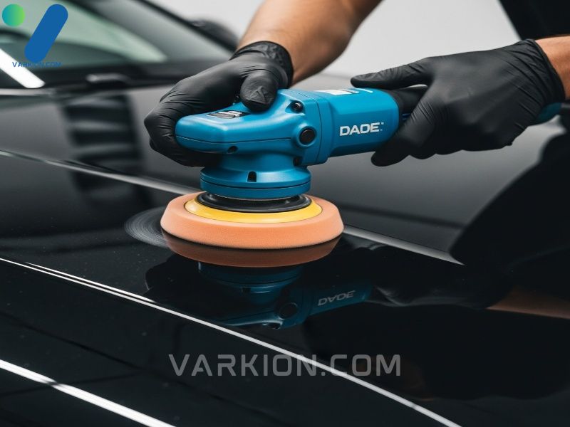 detailer-using-a-da-polisher-with-a-foam-pad-on-the-hood-of-a-deep-black-car