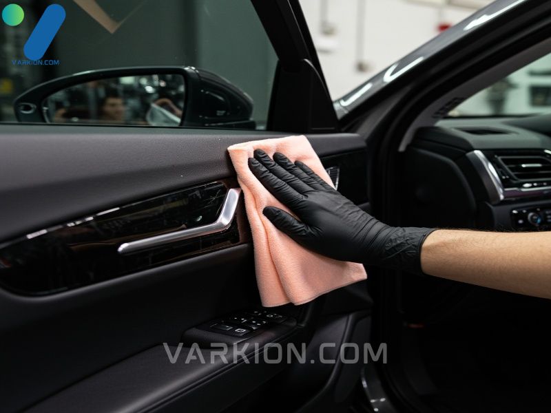 detailer-wiping-plastic-car-door-trim-with-a-microfiber-towel-to-achieve-a-streak-free-clean