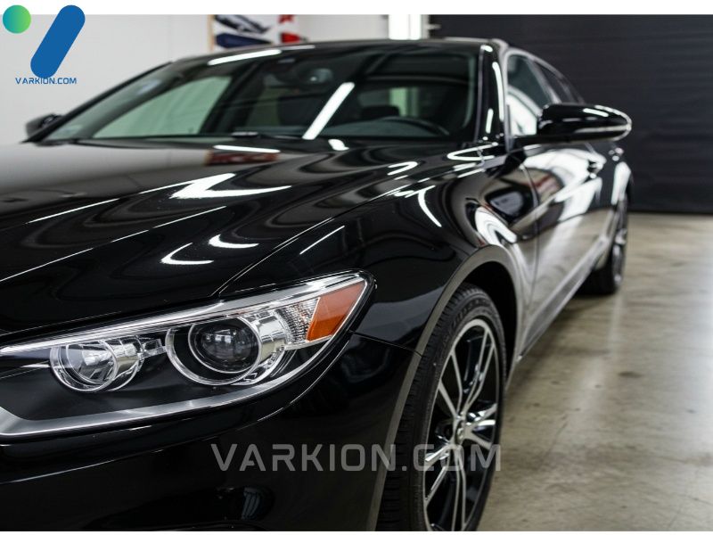 extreme-close-up-of-a-freshly-waxed-black-cars-mirror-like-high-gloss-reflection