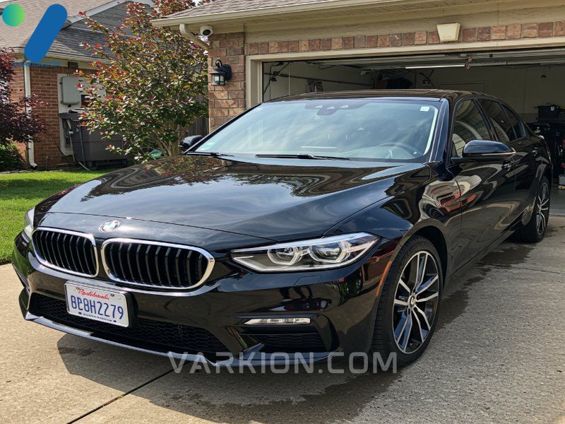 freshly-detailed-highly-reflective-black-car-parked-in-a-clean-driveway