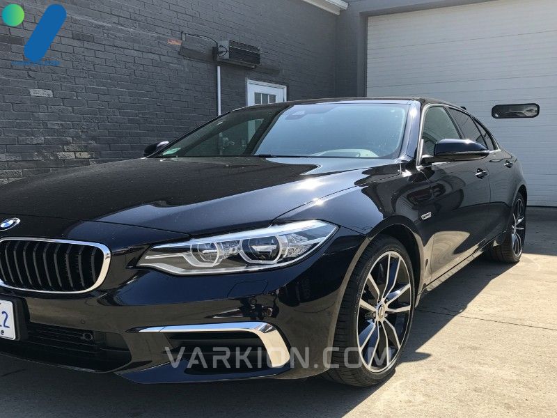 glossy-detailed-car-with-a-mirror-finish-parked-outside-a-garage