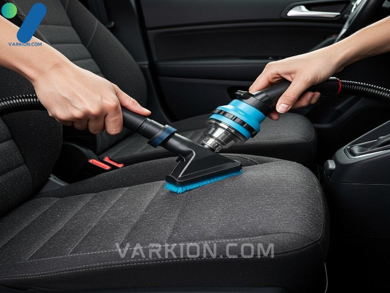 hand-vacuuming-dusty-car-interior-using-a-crevice-tool-between-the-seat-and-console