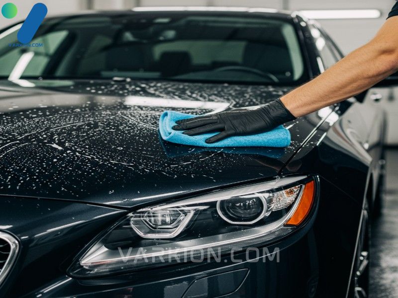 hand-washing-the-hood-of-a-dark-luxury-car-with-a-microfibre-mitt