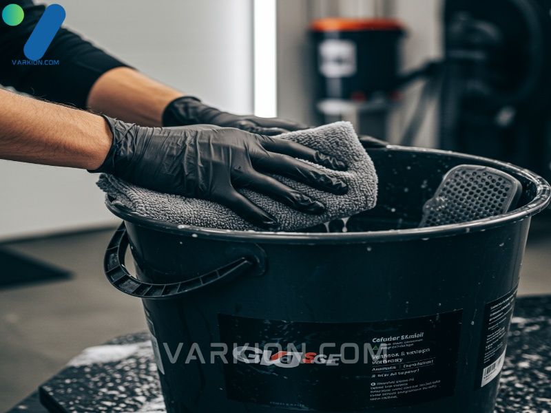 hands-dipping-a-plush-microfiber-mitt-into-a-wash-bucket-with-a-grit-guard