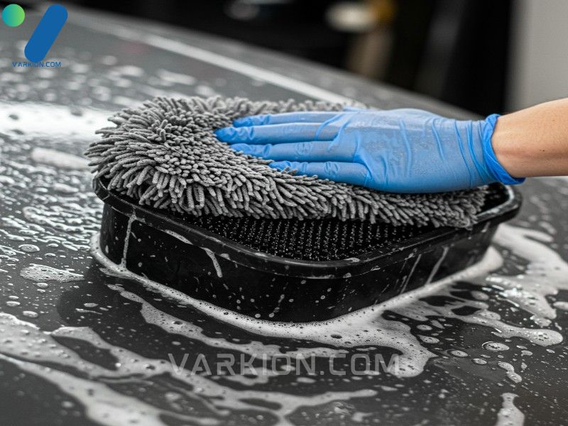 microfiber-wash-mitt-cleaning-against-a-grit-guard-in-a-bucket-illustrating-the-two-bucket-car-wash-method