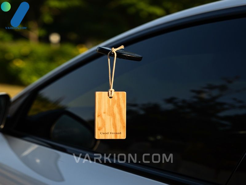 minimalist-cedar-wood-car-freshener-hanging-from-a-rear-view-mirror-in-sunlight