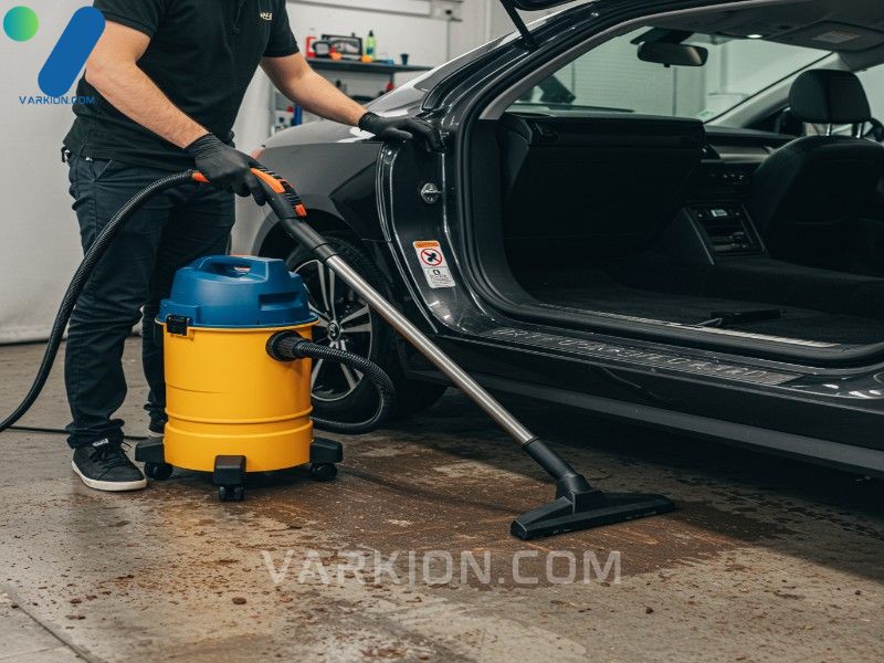 professional-detailer-vacuuming-deeply-embedded-dirt-from-a-cars-footwell-carpet-with-a-shop-vac