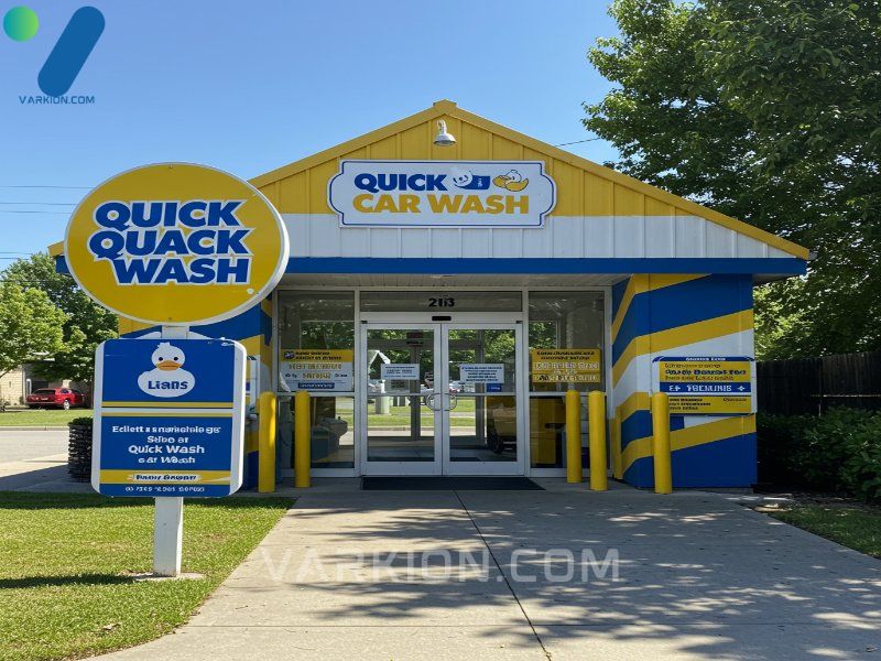vibrant-quick-quack-car-wash-entrance-featuring-yellow-and-blue-branding-and-the-iconic-duck-mascot