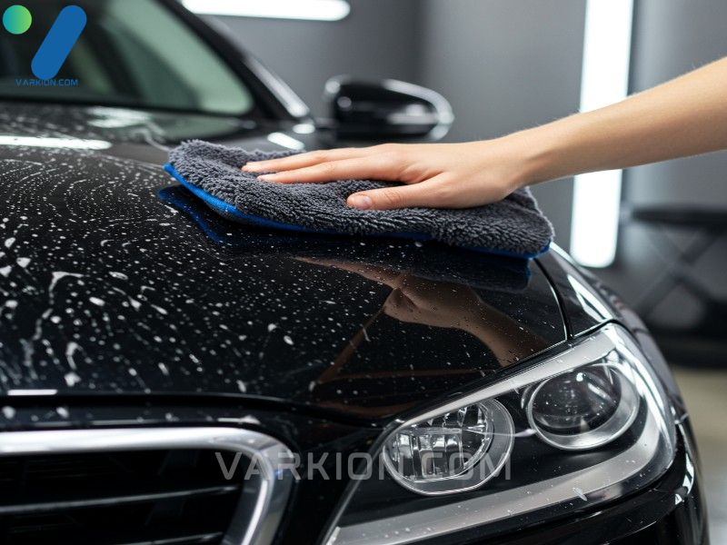 wash-mitt-gliding-smoothly-over-a-clean-reflective-black-car-surface