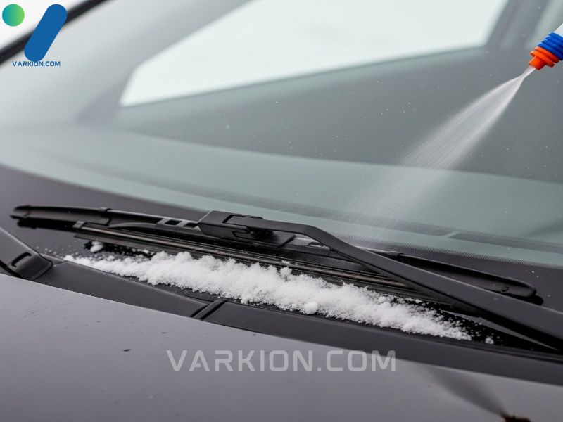 windshield-wiper-blade-actively-clearing-snow-and-road-grime-with-de-icer-fluid-spray-leaving-a-clean-path