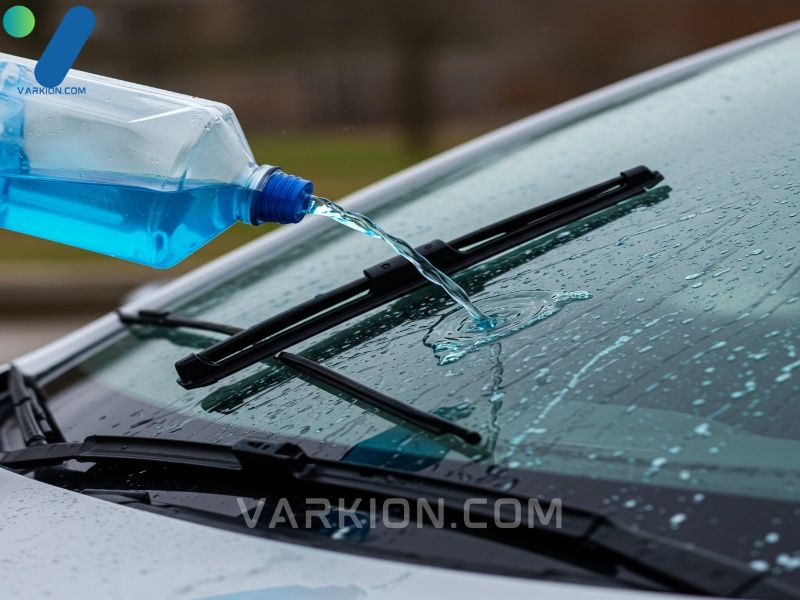 wiper-blades-cleaning-a-windshield-with-blue-washer-fluid